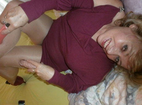 Busty mature woman Caro holds a cock after masturbating with sex toys