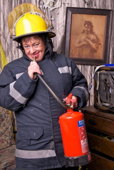 Mature fatty doffs her firefighter clothing to show her twat in stockings