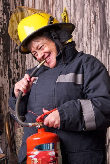Mature fatty doffs her firefighter clothing to show her twat in stockings