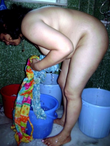 Indian fatty washes her clothes while taking a shower at the same time