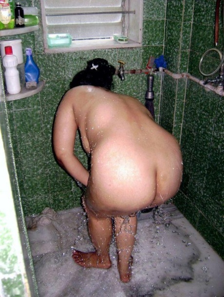Indian fatty washes her clothes while taking a shower at the same time