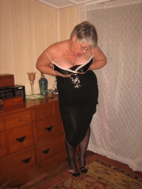 Overweight nan Girdle Goddess strips to her footwear in front of a dresser