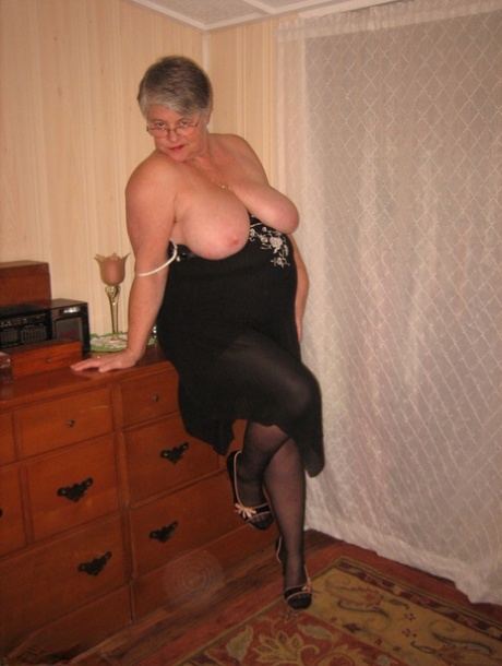 Overweight nan Girdle Goddess strips to her footwear in front of a dresser