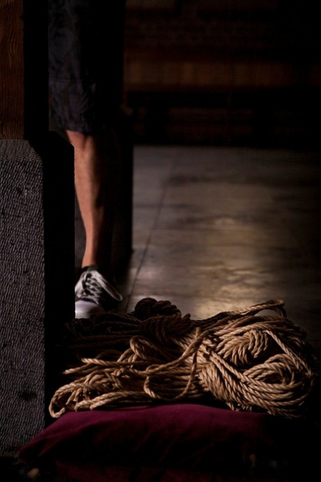 Naked British woman Sarah Calanthe is affixed to a wooden post with rope