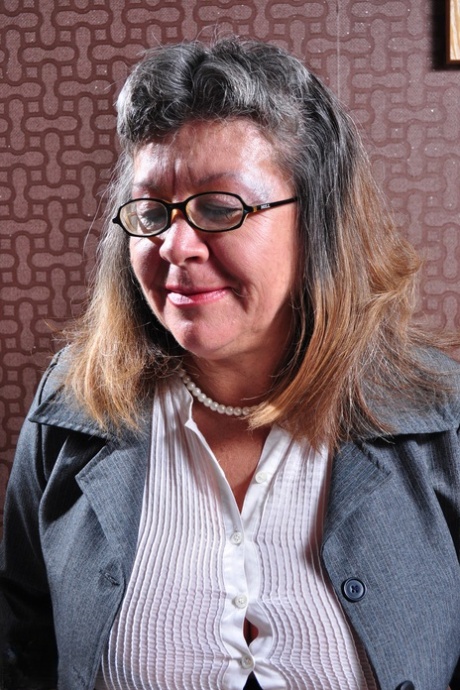 Mature woman in glasses Brenda S presents her big saggy boobs and masturbates