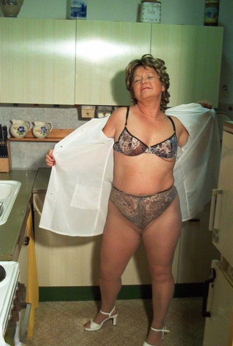 Petite granny Rita removes her dress and nylons and masturbates in the kitchen