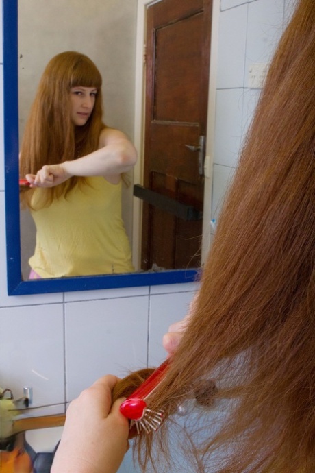 Ginger Chloe B unveils her big tits & ass before rubbing her pierced muff