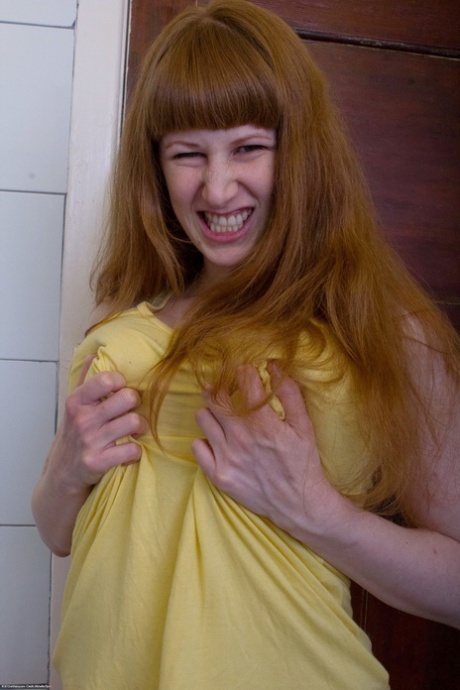 Ginger Chloe B unveils her big tits & ass before rubbing her pierced muff