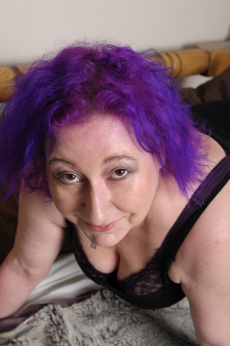 Mature with purple hair Nataline shows off her big boobs & plays with tiny toy