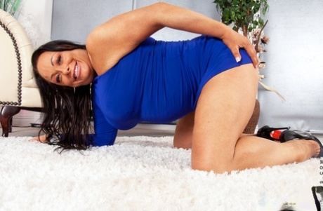 Busty cougar Alana B shows her firm melons and toys her juicy cunt