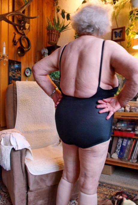 Lonely granny Galfira exposes her big saggy tits while changing in a solo